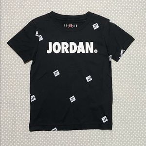 Jordan Black Short Sleeve T-shirt w/White “JORDAN” Text + Monogram Logo Pattern